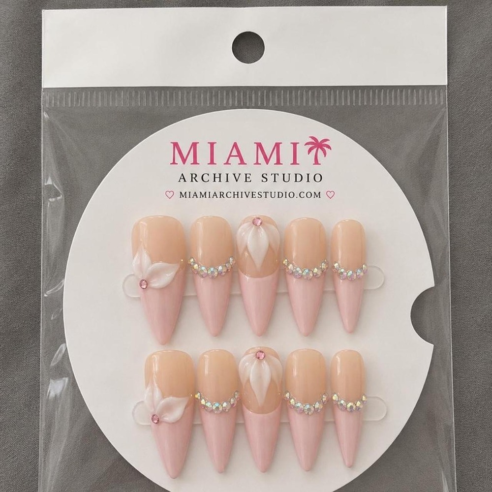 pink & peach rhinestone nails with white floral design